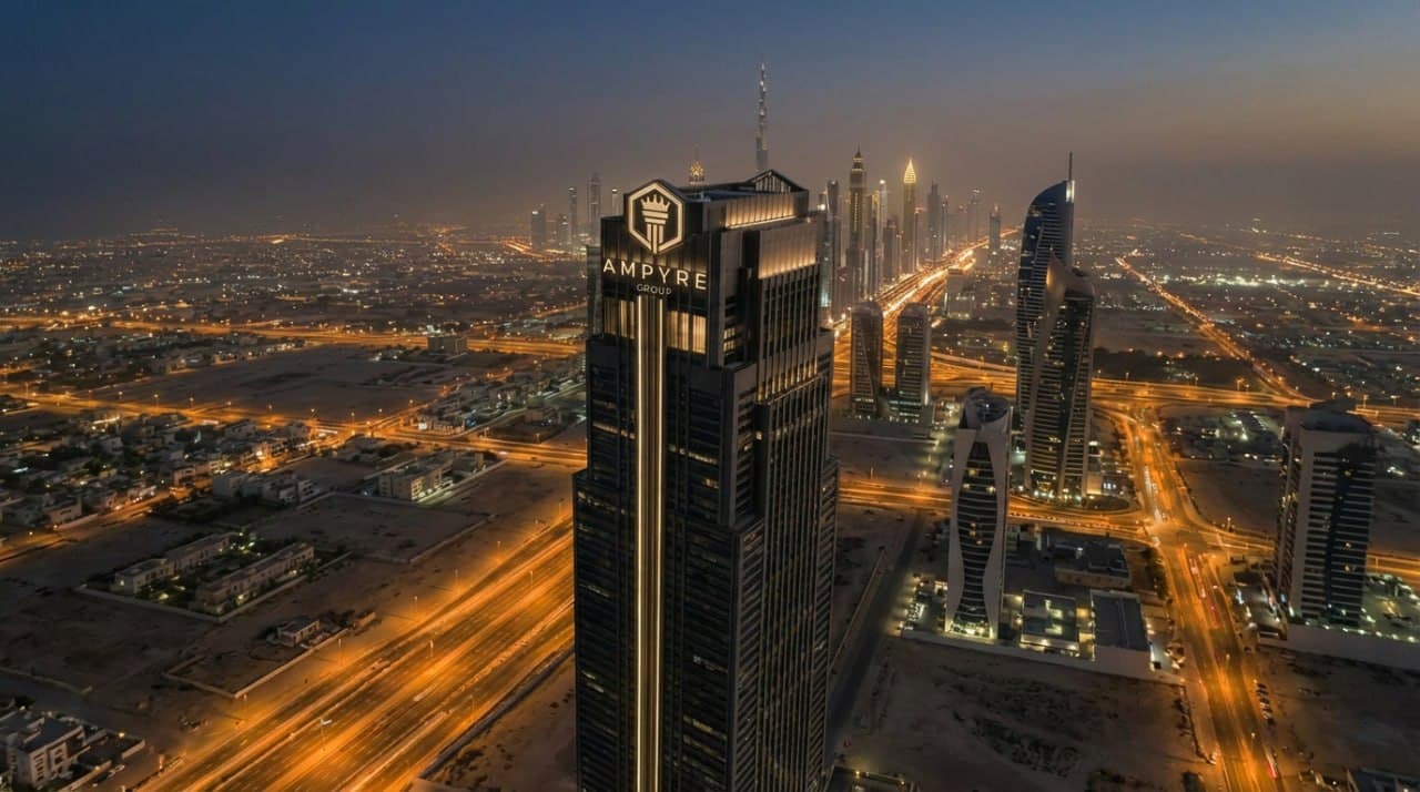 Ampyre tower in Dubai at dusk — gold city lights across the skyline